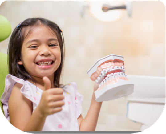 Young girl giving a thumbs up after an orthodontic screening for braces or alignment at Bunny Kids Dental