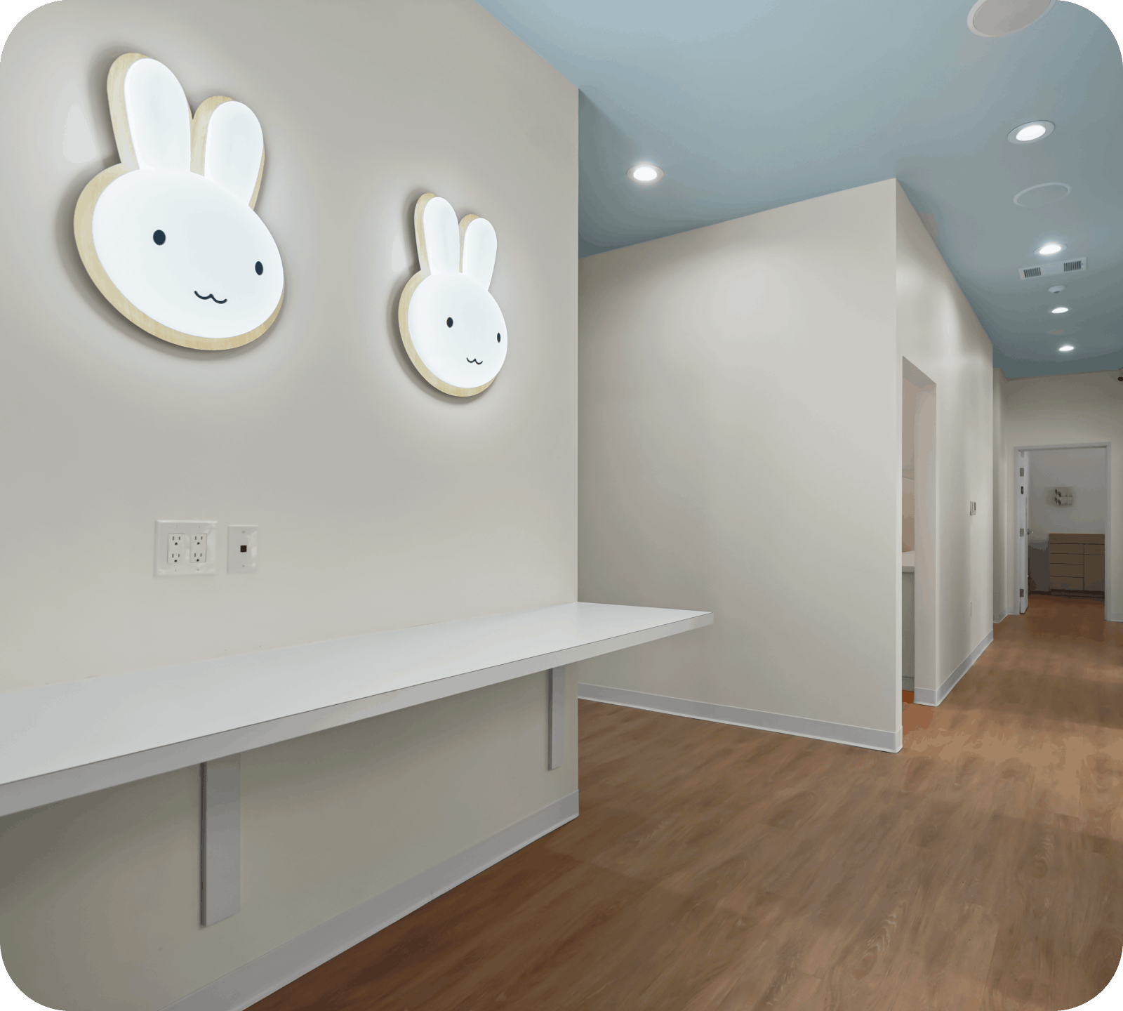 Cute bunny themed wall decor and clean hallway at Bunny Kids Dental