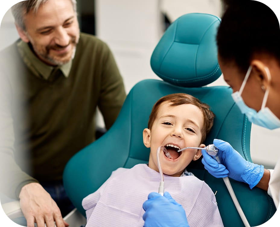 Happy young boy receiving gentle dental treatment and fillings at Bunny Kids Dental in Santa Ana